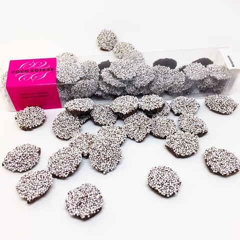 The Ultimate throwback to childhood, but now made with the finest quality ingredients and craftsmanship in the world. These classic Coco Suisse Nonpareils are dark Swiss chocolate buttons topped with crunchy nonpareils. While just looking at them will put a childlike smile on your face, eating them will satisfy your senses with magnificent Swiss chocolate flavors.